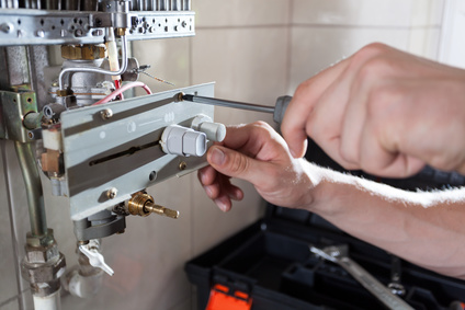 Close-up of a gas water heater reparation